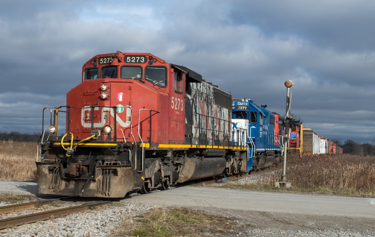 CN L580 is lead towards Hagersville amid a brief pocket of sun with a sweet consist of CN 5273, GMTX 2277, CN 9416.