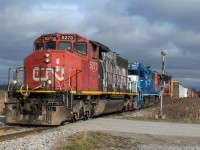 CN L580 is lead towards Hagersville amid a brief pocket of sun with a sweet consist of CN 5273, GMTX 2277, CN 9416.