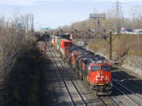 A shorter than usual CN 120 (456 axles vs an average of 620-630 axles) is exiting Taschereau Yard with CN 2875, CN 2964, CN 2655 & CN 2622 for power (and no DPU, uncommon), the last of which is isolated in deference to its shorter length.