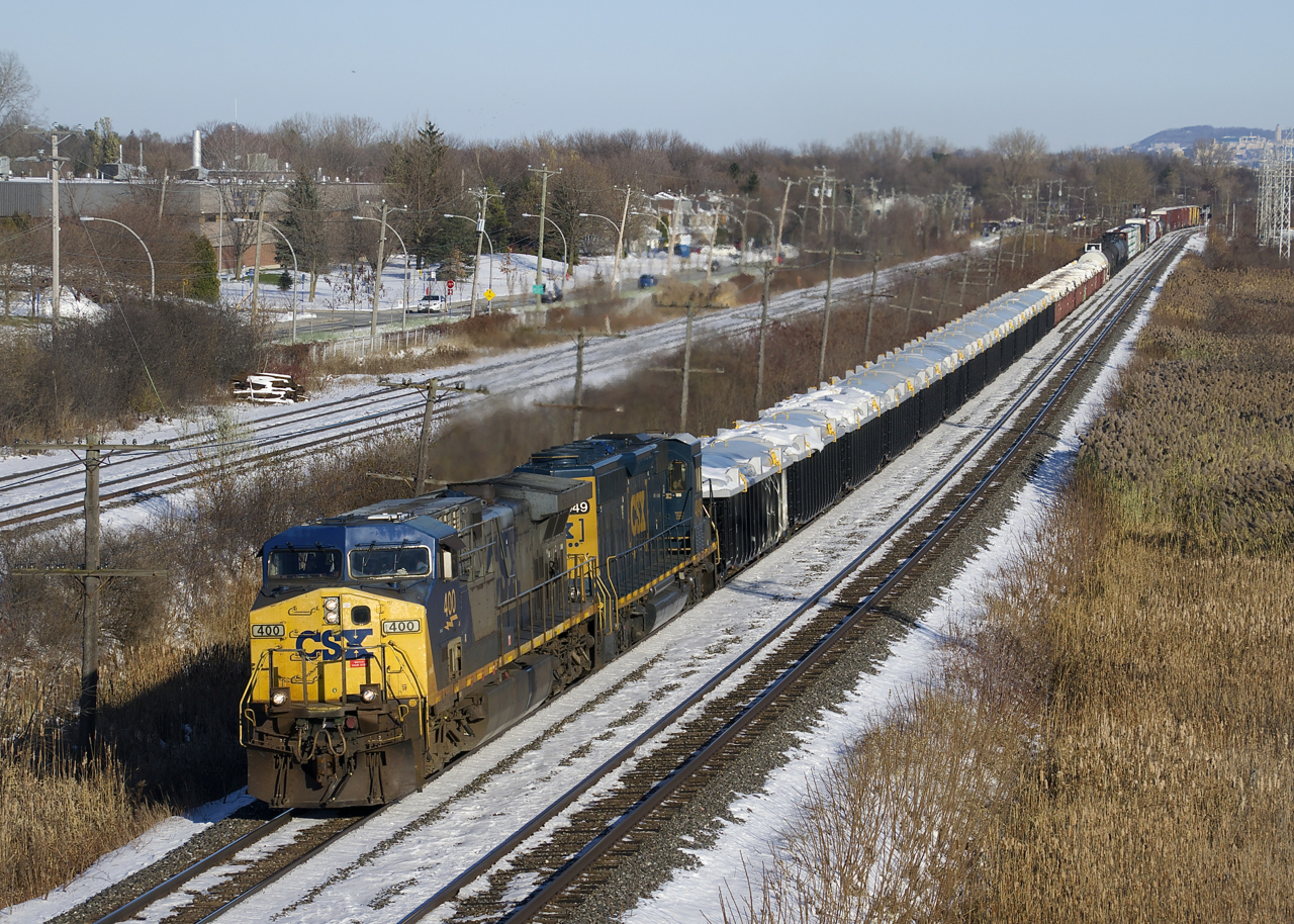CSXT 400 and CSXT 4049 lead a short CN 327 (63 cars) through Pointe-Claire. Up front are a long string of gons (both new and old ones) containing zinc ore that will be set off at Coteau.
