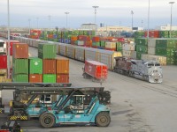 The first of CP's military units to arrive in Montreal (CP 7023) leads CP 112 through Lachine IMS Yard (with CP 8614 trailing), where it will set off cars. CP 7023 is painted in an Air Force-inspired paint scheme and features an American flag on one side and a Canadian flag on the other side.