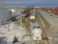 The first of CP's military units to arrive in Montreal (CP 7023) leads CP 112 (with CP 8614 trailing), as he sets off cars in the Lachine IMS Yard. CP 7023 is painted in an Air Force-inspired paint scheme and features an American flag on one side and a Canadian flag on the other side.