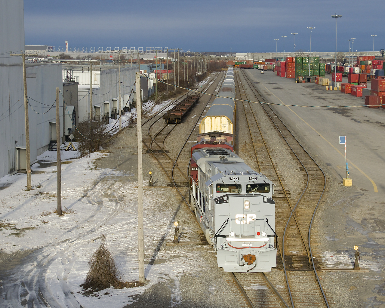 The first of CP's military units to arrive in Montreal (CP 7023) leads CP 112 (with CP 8614 trailing), as he sets off cars in the Lachine IMS Yard. CP 7023 is painted in an Air Force-inspired paint scheme and features an American flag on one side and a Canadian flag on the other side.