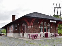 <br>  
<br>  
The restored  ( 2005 )  Edmundston CPR station originally built by the CPR circa 1930, from plans supplied by the office of the CPR’s Chief Engineer in Montreal.
<br>  
<br>  
 Restoration included retaining much of the original interior room and related woodworking. 
<br>  
<br>  
The station is a  Regional Information Center and the Edmundston Madawaska Tourism Office. Current transportation uses include a cycling trail rest stop and an electric vehicle recharge station, 
<br>  
<br>  
what's interesting
<br>  
<br>  
The 1930 station replaced a two story station built by a predecessor railway, the New Brunswick Land and Railway ( 1881 name change to New Brunswick  Railway ). 
<br>  
<br>  
CPR sold off most N B assets * (timber lands and railway lands, rights of way)  by 1941 to the Irving group, retaining operational rights. Most CPR  N.B. service ended circa 1987, * excepting CAR (McAdam) line.
<br>  
<br>  
The caboose: moved to CP Edmundston station location 2008 is ex CPR Angus built wood  caboose (number unknown) formerly at Grand Bay – Westfield N B ( thank you Trackside Guide)
<br>  
<br>  
September 5 2019 digital by S.Danko at Edmundston N.B.
