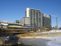 The combined VIA 601/603 passes the now obscured Wellington Tower with VIA 6438 up front and VIA 6405 mid-train.
