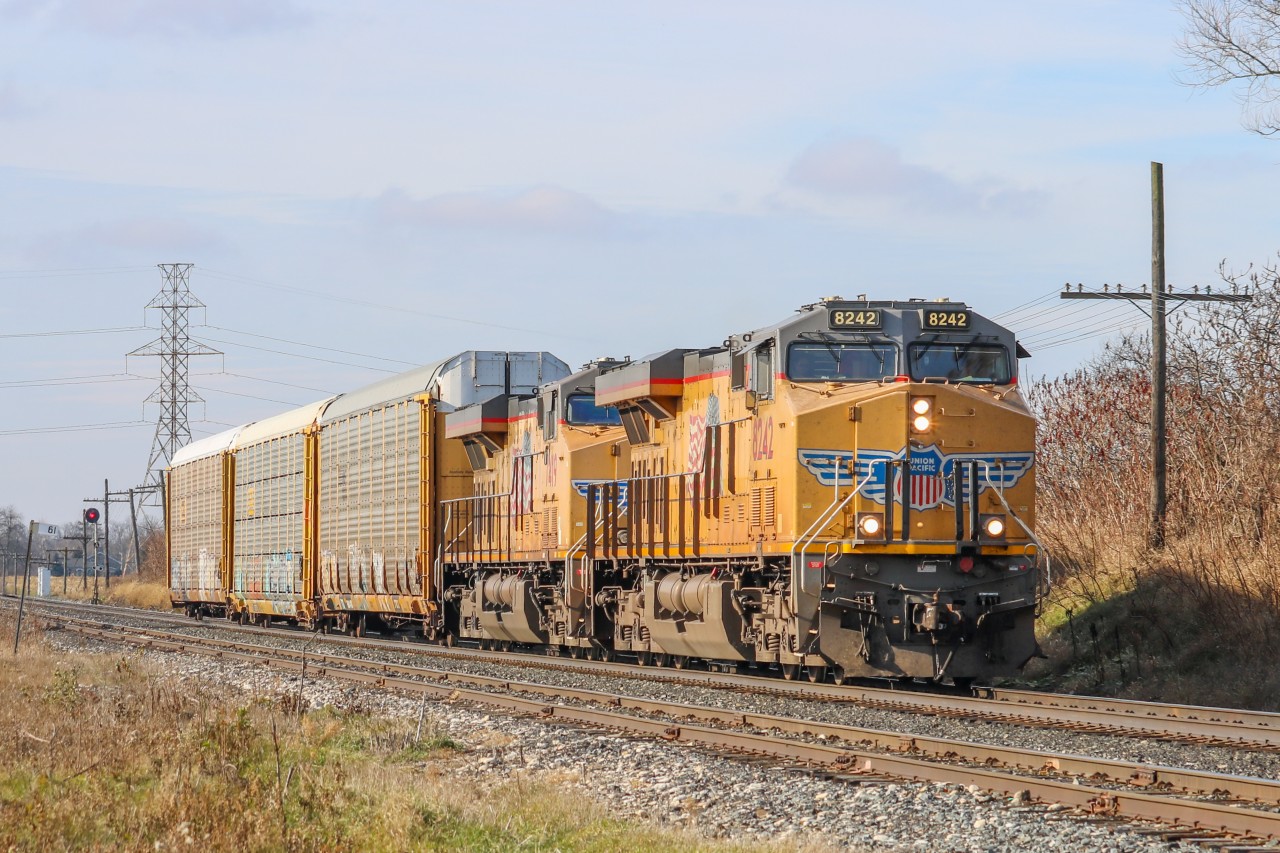 After meeting 235 at Wolverton, 244 flies through Orrs Lake with a pair of UP Gevos and 3 autoracks.