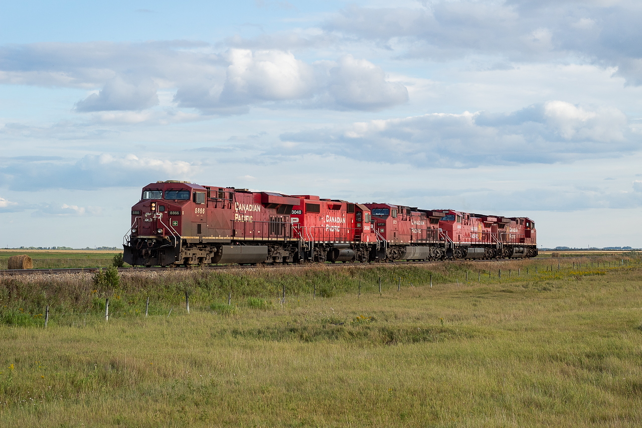 I was trying to head back to Saskatoon after a long day of railfanning around Keppel, Biggar, and Oban, and kept running into more and more trains on the way back to the city. I know, poor me, right? For this particular train, I was eastbound on Highway 14 heading back to Saskatoon and the flashers near Grandora were going but all of the cars ahead of me were ignoring them or oblivious to them as they weren't even slowing down for them. I figured they must be malfunctioning and was thinking of calling them into CP. No sooner did I pull up to them did this train appear on the Cominco Spur, so for the fourth time on the way back to Saskatoon, the chase was on again. A road parallels the Cominco Spur for a good way and I followed them at a snail's pace as they headed southbound, including over the diamond with the CN Watrous Sub. They were headed for the nearby Nutrien mine, where they would be lifting a unit potash train to head west with later that night. I heard on the scanner they were going to be configured 3-1-1, meaning 8866, 3048 and 9731 would end up on the head end.