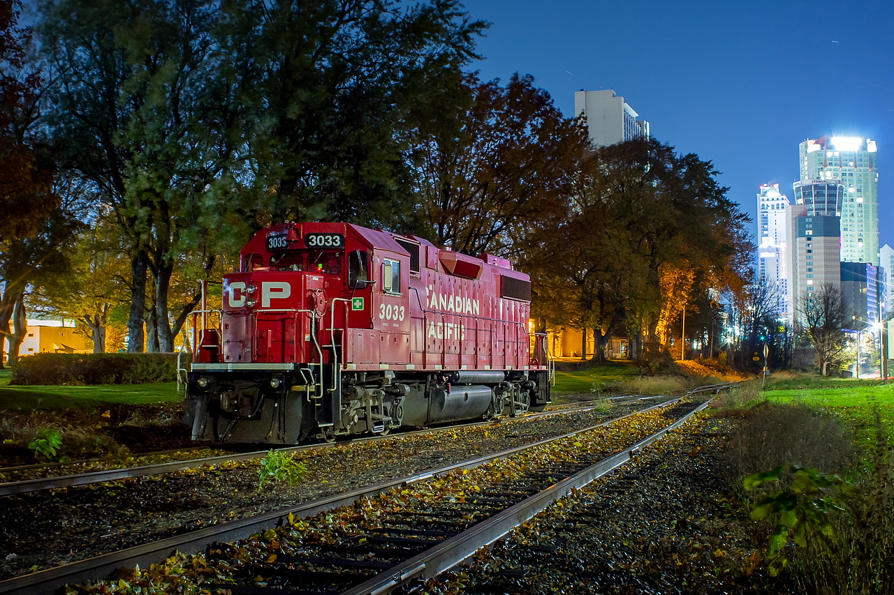 CP 3033 rests peacefully, idling away while it awaits the return of the crew of CP TE21 as they lift Washington Mills, one of only two customers on the Chippewa Spur (and to be honest I don't even know if Saint-Gobain is getting cars anymore). It should be noted that 3033 is resting on the Montrose Spur, and the track in the foreground is the Chippewa Spur. For those wondering about this move, it goes down as follows. After switching out Chemtrade on the Montrose, TE21 shoves any Chippewa traffic up to the junction here (on this particular night they came in light power, however). They drop one unit just shy of the switch, and then shove the rest of the train clear of the switch and then proceed down the Chippewa with one unit, long hood forward. They do their work on the Chippewa and then shove back up and tie onto the resting unit, which then leads on the return trip back to Welland. On this night, they lifted three two-bay hoppers out of Washington Mills. I've noticed from anecdotal observation of L562, TE11 and TE21, that a lot of Washington Mills traffic is interchange traffic from and to CN, exchanged at Southern Yard. Often there will be a 3800 cu. ft. cylindrical hopper, and gons are the norm too. Though probably not quite a true time machine shot, this Arnold Mooney shot from 1995 shows the area in a much different time. The two shots are in roughly the same location, though the trains are on different tracks. Much has changed in this time. Aside from the new hotels in my shot, the Chippewa is now restricted to four axle power, and only one unit is allowed. It's hard for me to picture that scene from 1995 to be honest.
