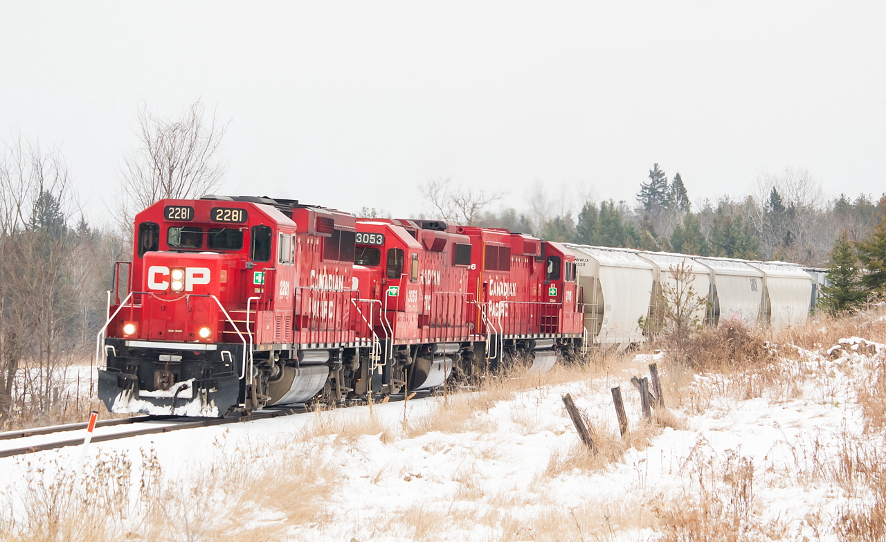 2281 leads a slow and steady T07 westbound on the Havelock Sub towards Toronto, just west of the town of Norwood.