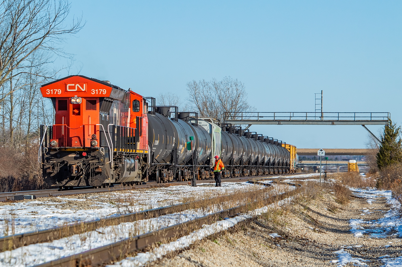I post this to share the shot, but to also share a bit of an update on Niagara area operations. I went down to Port Rob today on a hunch – the hunch being that CN has been keeping a unit in Port Rob lately, and that 562 was starting much earlier than they used to. For those who are unfamiliar, the jobs out of Port Rob (531/530, 539/538, 562, the rare 563, and 564) all use power that arrives on 421 and 330, which then typically leaves the following day on 422 or 331. Now it would seem there is a dedicated unit kicking around the yard for a number of days at a time. Port Rob formerly had four axle yard units assigned to it, though from my understanding it has been a number of years since this was the case.  This hunch began when I went down to Port Rob last Saturday, as 421 had an SD40-2W trailing in third. When I got there, 562 was already working, using 2134. Based on an OS elsewhere, the unit had arrived on a 421 several days prior, which had me a bit curious. Yesterday, I heard 562 talking to RTC after they had been taxied to Aldershot to relieve 421 in the afternoon, and they told RTC they were on duty at 0900 (as opposed to the 1400 or so I would normally expect). This also had me a bit curious. Given the two observations, I went to Port Rob today to test the hunch. I arrived and saw 422 leave, watched the crew of 562 build 331 (562 was on duty at 0900), and then watched 562 work the yard and make the run to Southern Yard and Feeder with the 3179. From an OS elsewhere, 3179 had been in Port Rob since November 12. The hunch was indeed confirmed, and CN has been keeping a unit assigned to Port Rob of late.  Pictured here, 562 is on the CP Hamilton Sub, pulling ahead to clear the switch for Rusholme Siding (formerly Brookfield Siding, where the racks are stored), on which they will shove back on to clear the switch for the Trillium Cayuga Spur (in the foreground) to access Feeder Yard for interchange. Note the CP sign indicating the limits between Trillium/CP. I should also note that when CN sets off its interchange traffic for CP at Southern Yard, they typically make their lift of traffic returned by CP at the same time. Meaning, not everything pictured in this shot is necessarily for set off Feeder, but rather some of it is just along for the ride. Ultimately, they returned to Port Rob with a good 50 or 60 cars.