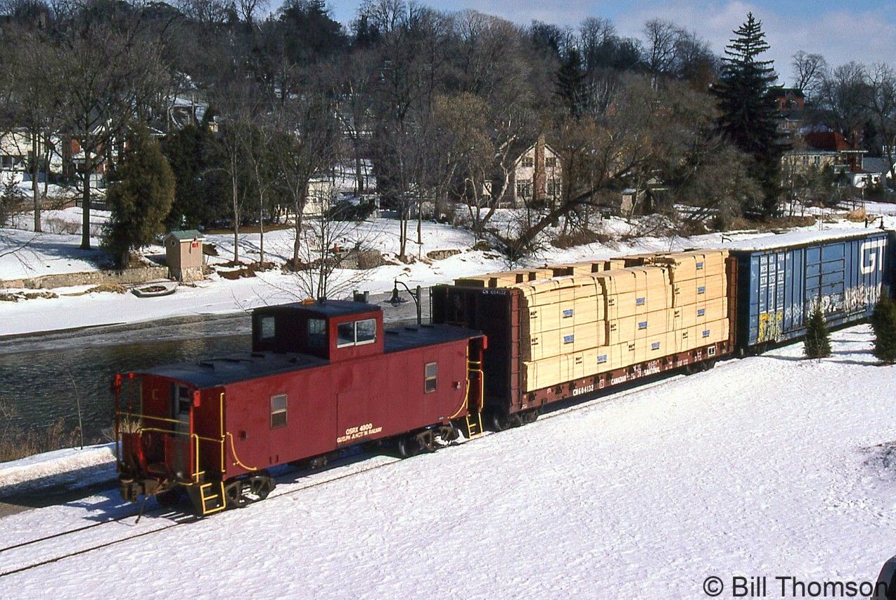 Ontario Southland van 4900 trails the freight lead by RS23's 503 and 505, running along the Speed River in Guelph on the Guelph Junction Railway.

4900 was an older steel center-cupola caboose (or van, in CP parlance) acquired by OSR from CP in 1998, and was formerly CP 434900 (it had been renumbered into that 4349xx international service number series from a previous 4341xx-series number). In recent years, it has been out of service and stored at Guelph Junction.