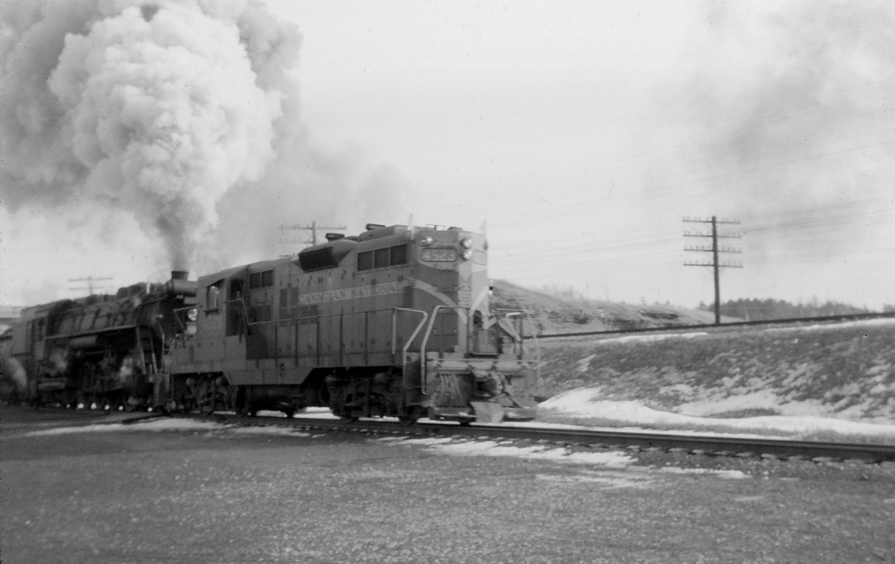 In early 1959, you could still find steam power handling mainline trains on CN in southern Ontario--but not for long. According to Don McQueen's Canadian National Steam!, midnight May 31, 1959 was "the effective dieselization of Central Region. All steam stored for emergency use." So, savour this view of GP9 4523 assisting Northern (4-8-4) 6112 through the "Cowpath" and up the Copetown hill...it is a show that will only continue for a few more months.