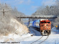 Passing under a wooden farmers bridge, a CP Windmill train from the QGRY heads west on the Galt sub after a snow storm. It's amazing how a change of the seasons can make a boring location look really interesting over time. With a day so nice like this, you'd thikn I'd have chased this thing to London - but I didn't - I chased only 10 miles. Wish I went longer! Note this is a second take, some active users may have noticed I posted a different crop earlier, realized I didn't like it, rejected it and went with this one instead.
