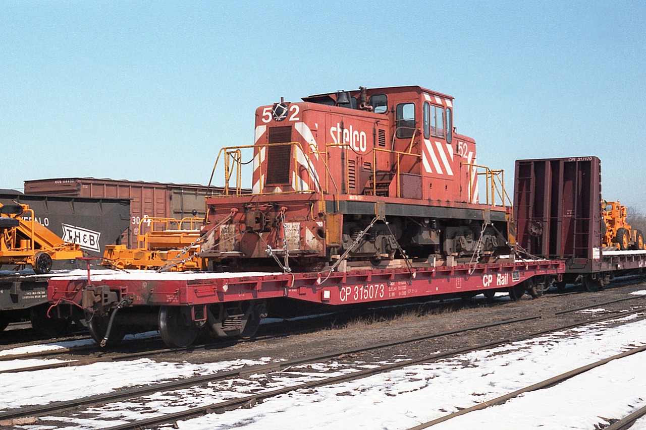 Sitting in the old TH&B yard in Hamilton, all chained down and ready to roll is  old 1950-built centre cab #52 out of Stelco. It was being transferred to a Stelco subsidiary in Edmonton, Alberta. Wondering if it is still out there............