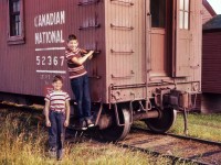 A slide taken by my Dad and seeing how old my brothers are here, I will say the time is 1958. The best I can guess on location is in the Edmonton area. Lucky day for my siblings, getting to spend time at work with Dad. I spent a few days there myself in the early 60's when he worked in the coach repair yard located at the City yard in downtown Edmonton. Leaf sprung trucks, upright brake wheel, and a not to easy to use pin lifter, besides various other items not to be found on cars today. I'm surprised the wheels do not have the little fins on the back of them for cooling. I hope you enjoy this small piece of my family's rail history. 