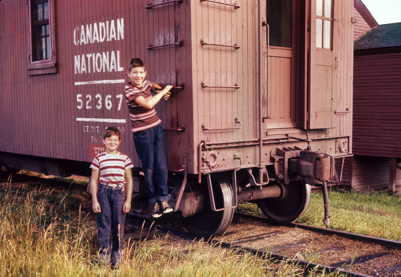 A slide taken by my Dad and seeing how old my brothers are here, I will say the time is 1958. The best I can guess on location is in the Edmonton area. Lucky day for my siblings, getting to spend time at work with Dad. I spent a few days there myself in the early 60's when he worked in the coach repair yard located at the City yard in downtown Edmonton. Leaf sprung trucks, upright brake wheel, and a not to easy to use pin lifter, besides various other items not to be found on cars today. I'm surprised the wheels do not have the little fins on the back of them for cooling. I hope you enjoy this small piece of my family's rail history.