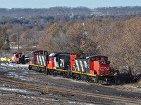 Two GMD-1 locos CN 1412 and 1437 with beltpack-capable GP38-2 CN 4719 between them are idling on the engine track at CN's Stuart St Yard in Hamilton on a rare sunny Sunday afternoon in November. <br>
Freshly repainted CN 4719 was seen arriving in the area on 23 Oct 2019; CN 422 dropped it off in Aldershot Yard.<br> 
Also working in Hamilton yard together were blue GP38-2 GMTX 2163 and GP9rm CN 7029.<br><br>
Coming this way later than usual is CN train 421, which dropped off a long cut of head end cars in the yard - quite a number were gondalas loaded with steel slabs.