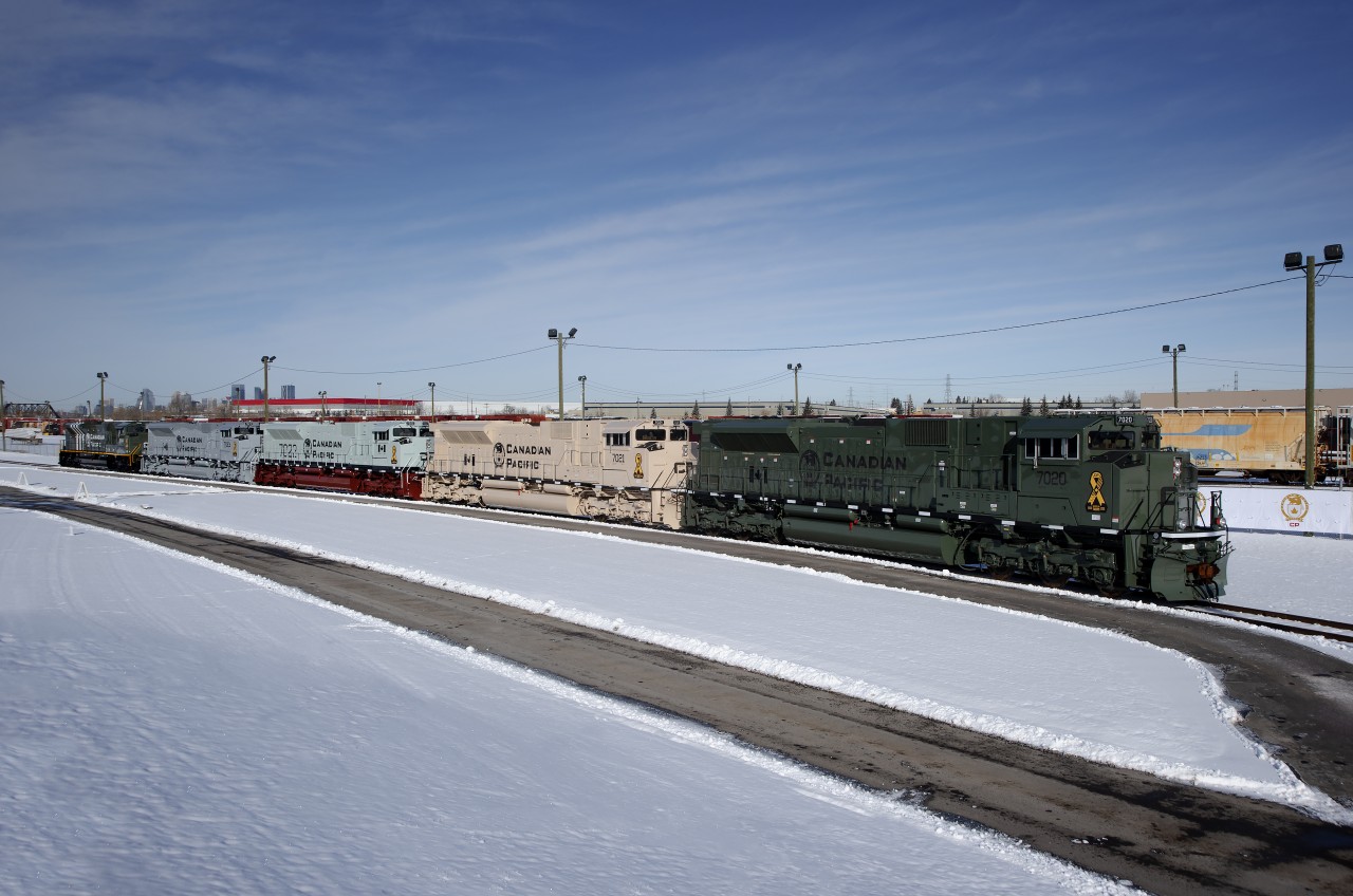 On November 11th, 2019 (Remembrance Day in Canada), Canadian Pacific unveiled 5 brand new SD70ACUs at their Ogden Yard wearing various military schemes. In order from right to left, CP 7020 wears the Army Temperate Regions scheme, CP 7021 wears the Army Arid Regions scheme, CP 7022 wears the Navy Scheme, CP 7023 wears the Air Force scheme and CP 6644 (renumbered from 7024) wears the World War II Memorial scheme.