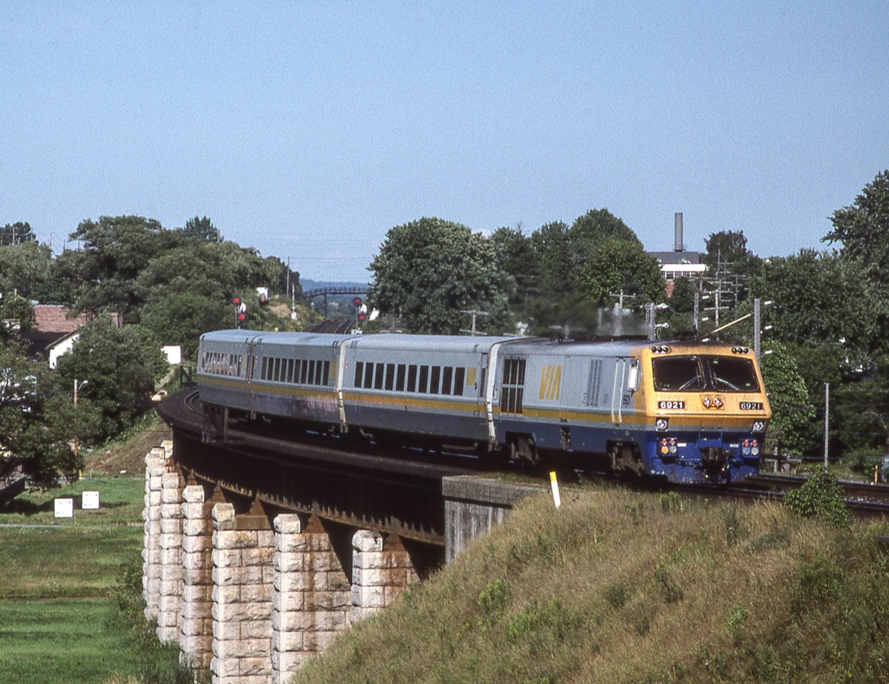 A short train headed by VIA 6921 crosses the bridge in Port Hope, Ontario on August 6, 1987.