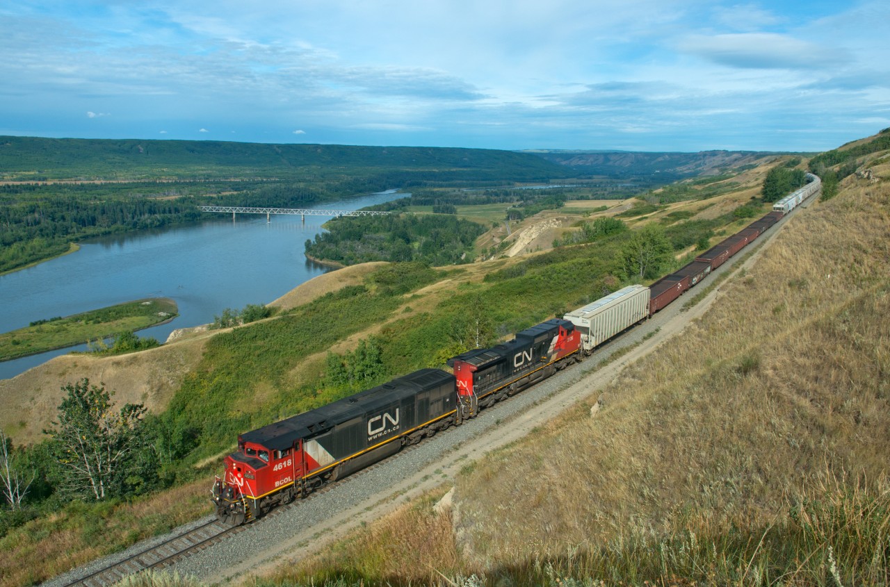 A delightfully rare morning move on the Fort St John Sub makes its way down north Taylor hill. The lead unit is about pass mile 719, the massive bridge across the Peace River bellow is located at mile 715. This is a hefty drop to make in 4 miles, only to then face the same grades up the other side.