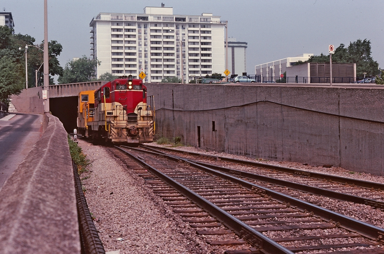A photo from Ron Tuff, captures the TH&B "east local" Port Maitland job exiting the Hunter Street tunnel. Must have been a light day tonnage wise with only one venerable GP-7 doing the work.