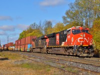 148 rushes by the feed mill at Copetown headed for an unusual stop at Aldershot to lift 4 stack cars and place them about 7000ft back in the train.  This was a few days into the new intermodal venture between CN and CSX, with only a handful of cars to lift on the trip.