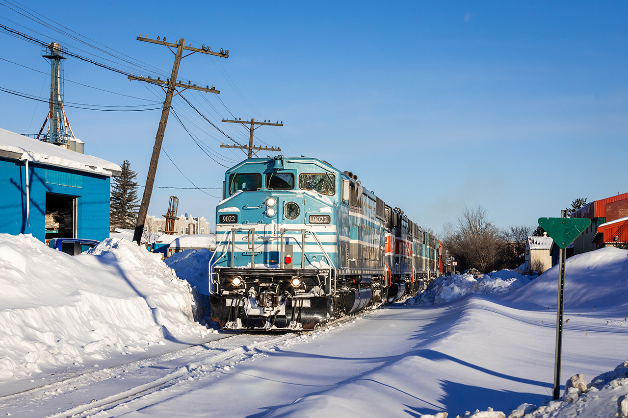 A quintet of Central Maine & Quebec SD40-2Fs ease US-bound train no. 2 along the snow-covered back streets at Lennoxville, Quebec on a glorious winter's morning.
 
At the time (for reasons to me now unknown), I was very disappointed with the results of this chase. I had accidentally set the image stabilizer on my lens to "Mode 2", which I was convinced had ruined my photographs. However, less than a year removed from that fateful February morning, and with the news of CP's impending takeover, I can easily look past whatever bad maple syrup I was drinking. Time heals all.