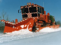 CN 433-21 is a brand new Plasser MPMV (Multi-Purpose Maintenance Vehicle), or Crew Crane Transporter (CCT), and is being mainline tested near Charny, Quebec back in December 1988. This machine concept was introduced when CN accelerated the downsizing/consolidation of section forces and utilized multi-function machines to offset the reduction in manpower. One phase of the project was known as TFM (Track Force Mechanization) and involved the development of manned camps at several remote locations in northern Ontario in the pilot project.