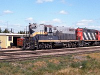 Stumbled on a clue a few days ago which lead to the note I wrote down for this train in 1985. The previous day, these units headed out as 836 with jet fuel tanks for the air base at Cold Lake. This photo shows it returning to Edmonton as an extra with empty tanks for the IOL refinery and loads of grain. The trailing units are the 4285 and 4316. Passing through town at lunch hour, we find the section guys stopped in and going about whatever business. The speeder will shortly be back on the rails, taking the gang to their afternoon work. The 4610 will be rebuilt into the 7221, which appears to have left the roster 4 or 5 years ago. There is a sad picture of the 7221's empty long hood on a flat car at the CNR photos website, dated Feb. 2015.