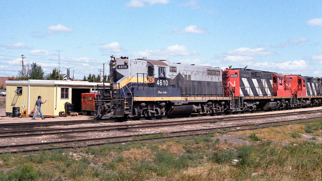 Stumbled on a clue a few days ago which lead to the note I wrote down for this train in 1985. The previous day, these units headed out as 836 with jet fuel tanks for the air base at Cold Lake. This photo shows it returning to Edmonton as an extra with empty tanks for the IOL refinery and loads of grain. The trailing units are the 4285 and 4316. Passing through town at lunch hour, we find the section guys stopped in and going about whatever business. The speeder will shortly be back on the rails, taking the gang to their afternoon work. The 4610 will be rebuilt into the 7221, which appears to have left the roster 4 or 5 years ago. There is a sad picture of the 7221's empty long hood on a flat car at the CNR photos website, dated Feb. 2015.