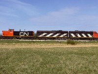 2 types of units that are favoured by many of us, but, not often seen together. In particular as an ABA set. Plus a couple of other oddities, ie. the 9190's reverse zebra stripes and short nose forward on the exNAR 1081. This photo taken from a farm field immediately north of Redwater. They have cut off from the ballast hoppers and are removing a bunch of parked flat cars out of the siding. There was already a bunch of these flats stored on the abandoned portion of the Lac La Biche Sub. at Egremont. These 20 flats will be joining them. When time came to return these flats back into service, this created one of the longest trains I ever witnessed in Redwater as they passed through town headed back to Edmonton.