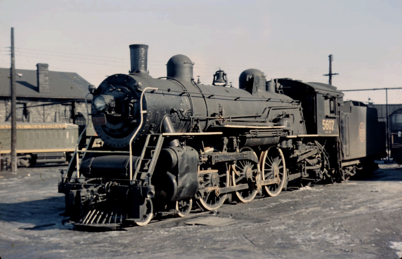Pacific (4-6-2) 5607 rests outside the Hamilton roundhouse in early 1959. For many years, she was one of the regular engines on trains 173/174 to/from Palmerston and Owen Sound (via Guelph), occasionally operating on the Allandale trains (660-661 and 662-662) when the diesel car was not available. According to Ian Wilson's research ("Steam Echoes of Hamilton" book), the 5607 made her last run to and from Palmerston on November 27, 1958--so this photo was taken only one or two months after she was stored.