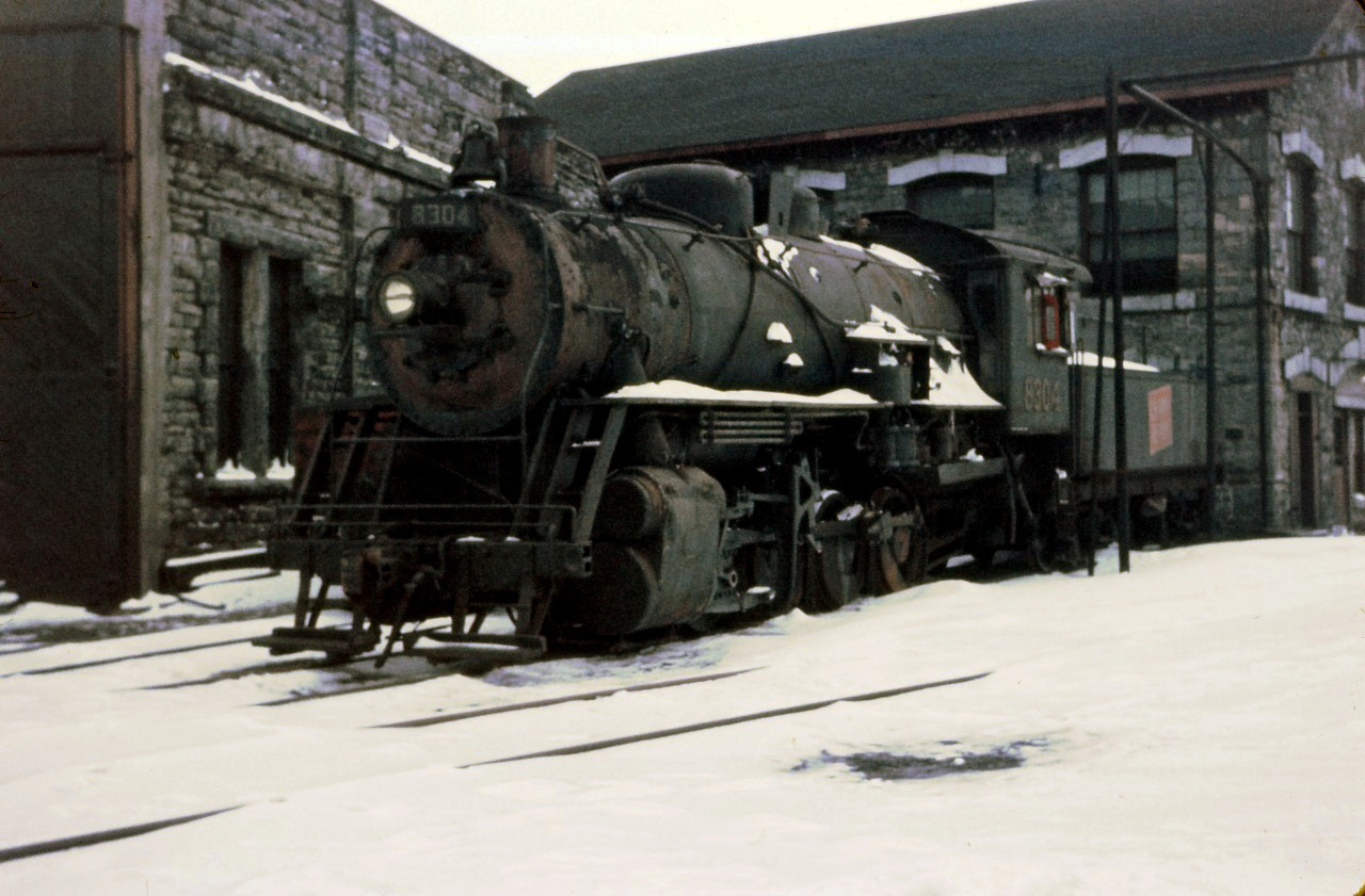 Here we have another shot of "heavy" yard engine 8304, an 0-8-0, in storage next to the Hamilton roundhouse (with the bunk house in the background). According to Ian Wilson's book, the 8304 was the last steam yard engine used in Hamilton on May 15, 1959.