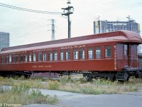 Restored CP "First Class" coach 141, dating from the early 1900's, is seen at John Street coachyard in downtown Toronto, brought out of storage for Railway Days in October of 1973. In the background, you can see the Toronto Star's office tower at 1 Yonge Street, and another high-rise tower under construction along the harbourfront.
<br><br>
During the planning of CBC's "The National Dream" series (with Canadian host Pierre Berton) in the early 1970's, CP was looking for old equipment suitable for use in the series of episodes portraying the creation and building of the railway. This car was originally built by CP's Angus Shops in July 1907 as suburban coach 141, and at the time was one of only three such cars left, assigned to OCS / Maintenance of Way duties on the DAR and numbered 411585. Originally a sister car was the one picked, but after it was damaged in transit, car 411585 and the remaining other car (for parts) were shipped to Weston Shops in Winnipeg for restoration in 1973. 411585 was given back its original number 141, and decorated to represent an earlier era for filming the 1870/80's-ish footage. The car, along with famed CPR 4-4-0 steamer 136 were both featured prominently many scenes of The National Dream. CP later donated 141 in 1980 to the Calgary Heritage Park, where it currently resides on display and restored to its original varnished wood exterior.