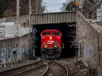 Determined to make it home for Christmas Eve, the crew aboard train no. 246-24 waste no time as they negotiate the confines of the Hunter Street Tunnel. Even amongst the gritty backstreets of Hamilton, SD70ACU 7006 looks particularly brutish.  