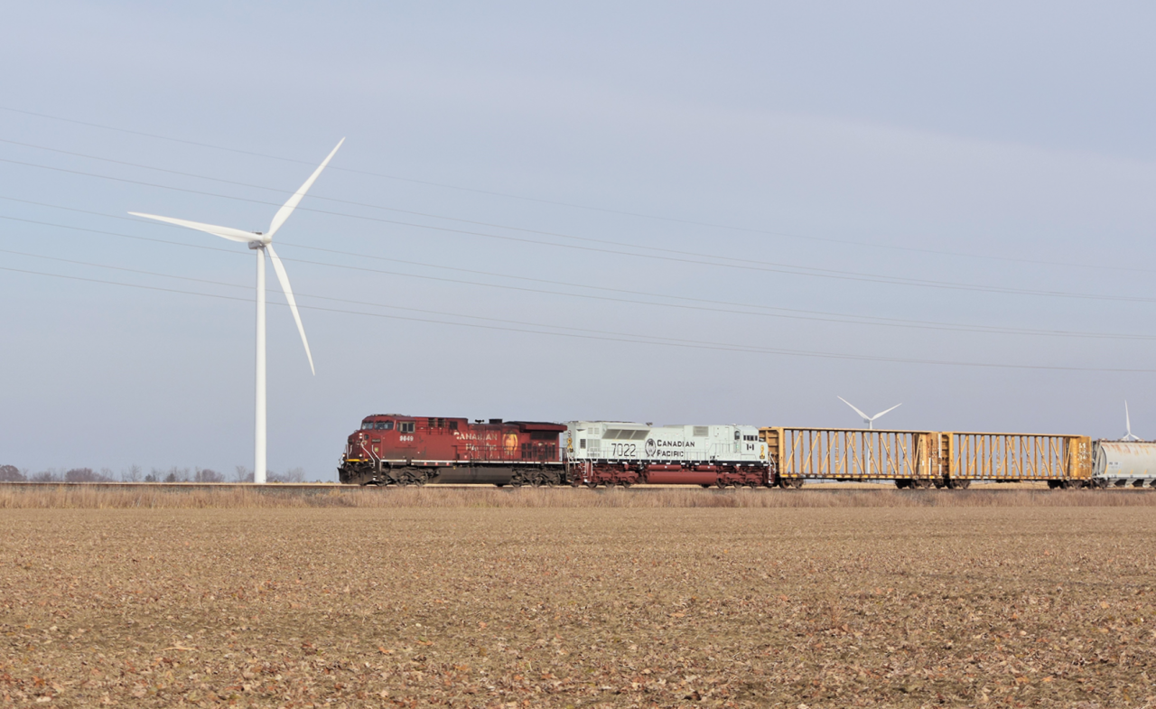 CP 235 with the first of the 5 Military units to venture down into Southwestern Ontario rolls through the flat harvested landscape of Essex County. Many will say that the Wind Turbines littered around this area are an eye sore.