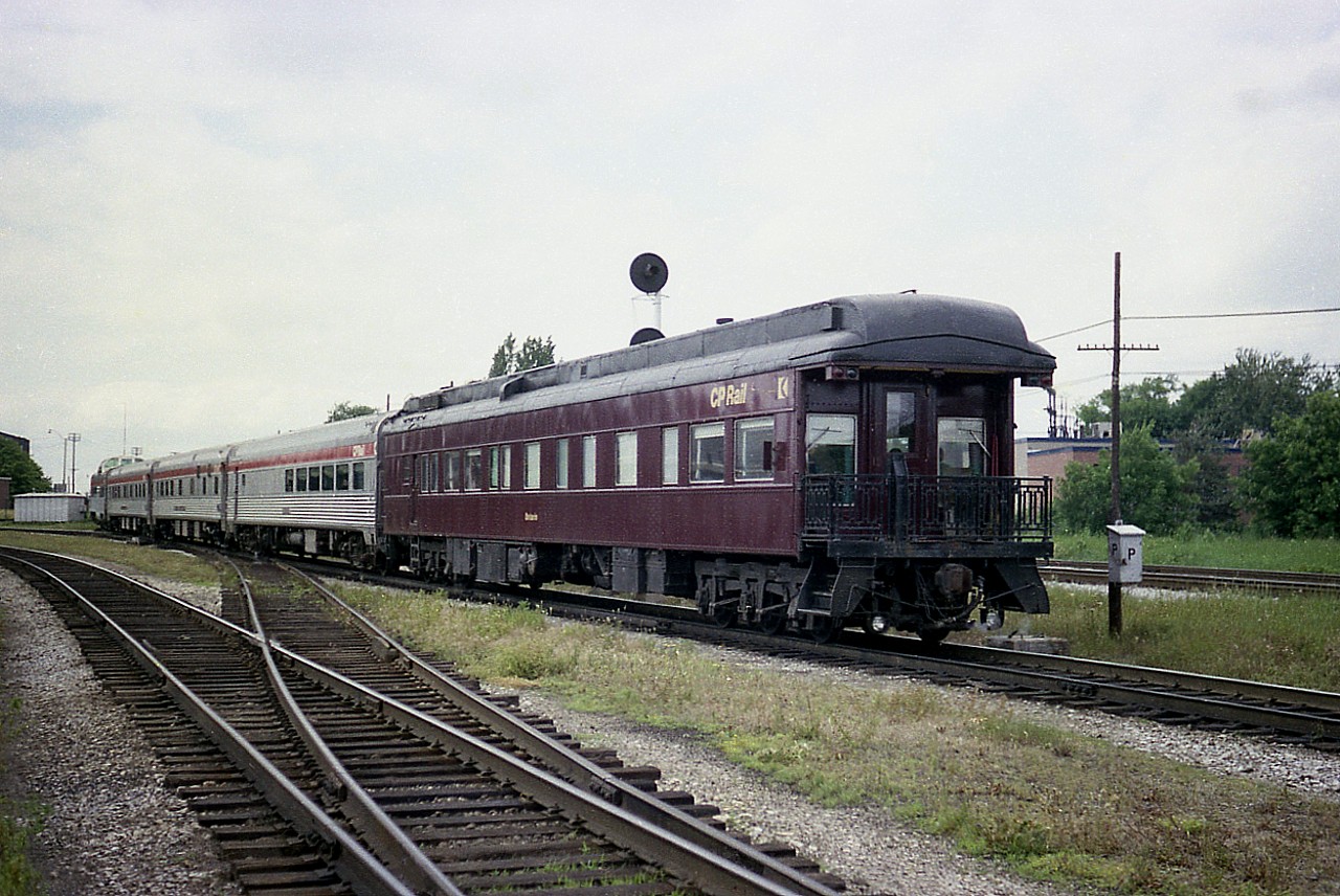 Just the other day I posted an image of CP 4066 powering the "Canadian" out of West Toronto en route to Sudbury, and one of our experienced hawk-eyed viewers noticed a Business Car on the tail end. And since information on this business car was gratefully submitted it was best I offer up a photo of this CP "Ontario" car.
I was told: "It was built by CP in October of 1927 as the "Mount Royal". It became CP "Ontario" in October 1969 and reverted back to the original name Mount Royal in 1989. This business car #73 carried the initials STLH in the 1990s as it was part of the St. Lawrence & Hudson division of CP in that time frame."
 Ninety two years have gone by and this car is still in service as part of the Royal Canadian Pacific tour series. The car is kept on hand at Calgary, Alberta.
 In this photo the train is just crossing the diamond at West Toronto heading north. I rather like the old phone box in the scene. Another relic of the past.