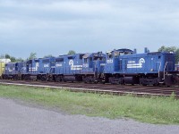For those who like the "big Blue", it still seems amazing this road has been gone for 20 years already. Back in the day, Conrail power was a frequent visitor to Fort Erie, having run traffic to and from the USA on an almost daily basis. Here is a nice lashup: CR 9573, 7938, 7936 and 7524, as seen ready to roll back to the USA.
The old Central Av bridge in Fort Erie is just barely visible over the auto rack.