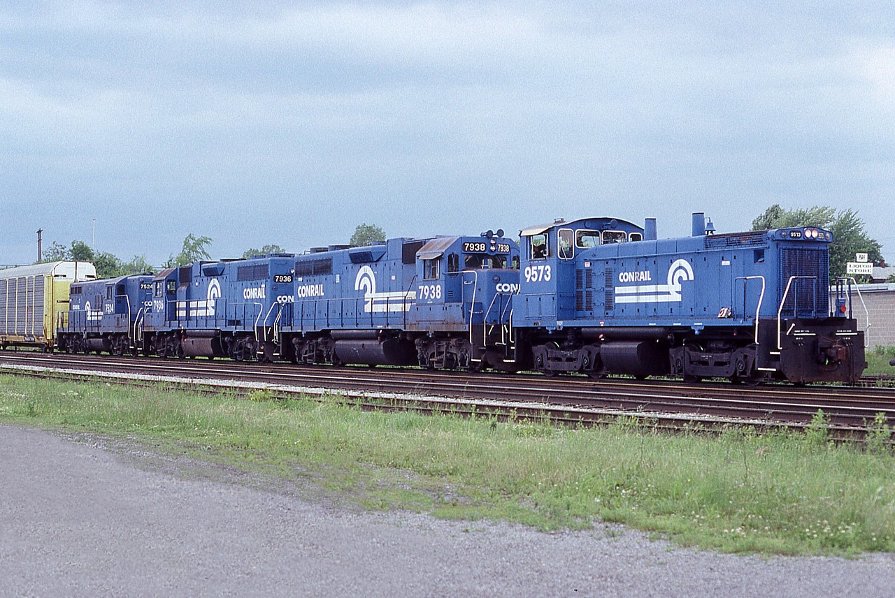 For those who like the "big Blue", it still seems amazing this road has been gone for 20 years already. Back in the day, Conrail power was a frequent visitor to Fort Erie, having run traffic to and from the USA on an almost daily basis. Here is a nice lashup: CR 9573, 7938, 7936 and 7524, as seen ready to roll back to the USA.
The old Central Av bridge in Fort Erie is just barely visible over the auto rack.