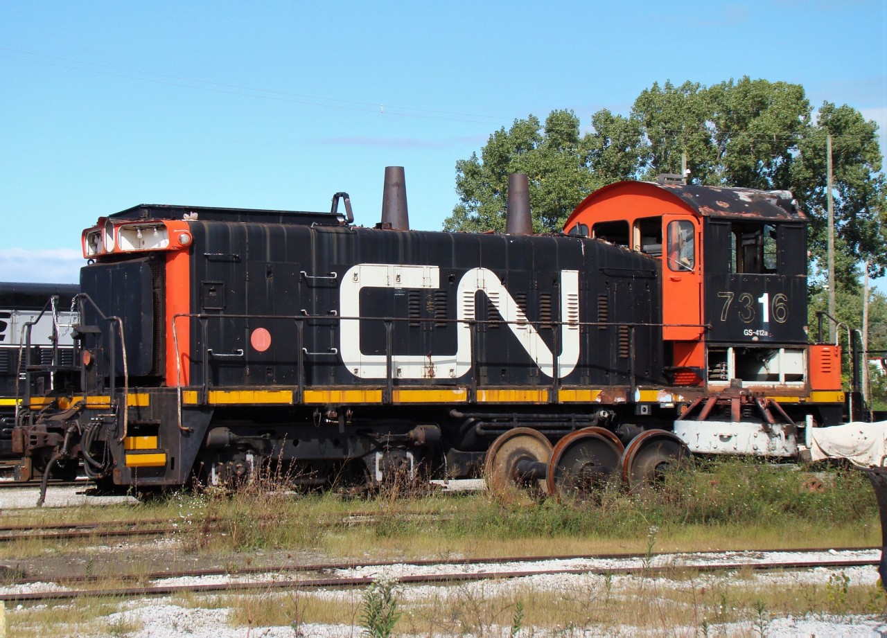 CN 7316 is seen here at Lambton Diesel partially cannibalized, looking like a parts engine. This is before the CN police station was built nearby, the workers there had no problem with me walking around with my camera as long as I stayed off the equipment.