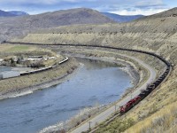 A loaded westbound CP coal train is seen approaching Ashcroft led by CP 8764.This view shows about 120 of the typical 152 cars that make up one of these trains, and also visible is the mid-train remote.