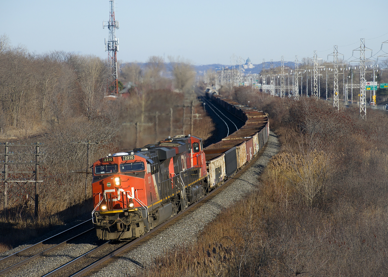 Formerly running on as needed basis from Southwark Yard to MacMillan Yard as CN X321, CN M321 is now a daily train between these two destinations. Here it is rounding a curve in Beaconsfield with CN 2310, CN 2234 and only 74 cars. It will pick up an additional 21 cars at Coteau.