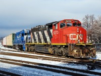 The first chore of the day for 580's crew is usually sorting out cars for the local industries that they will later switch, and today they were getting cars ready for Normerica (kitty litter), Ingenia (plastics) and Rembos (lumber).  It was clear and sunny first thing this morning but the clouds sure rolled in fast.  CN 5273 looks pretty good for 44 years old.  What I thought was original paint is not, as the unit has been repainted a few times.  If you look closely within the "C" on the nose there is the remnant of a smaller "CN" that looks more appropriate on the nose of a standard cab.  What's ironic is in the photo I found of the unit taken in 1987 with the small logo you can clearly see a larger "CN" logo through the red paint.  So at least the nose/cab has been repainted three times.  I find little details like this intriguing.   