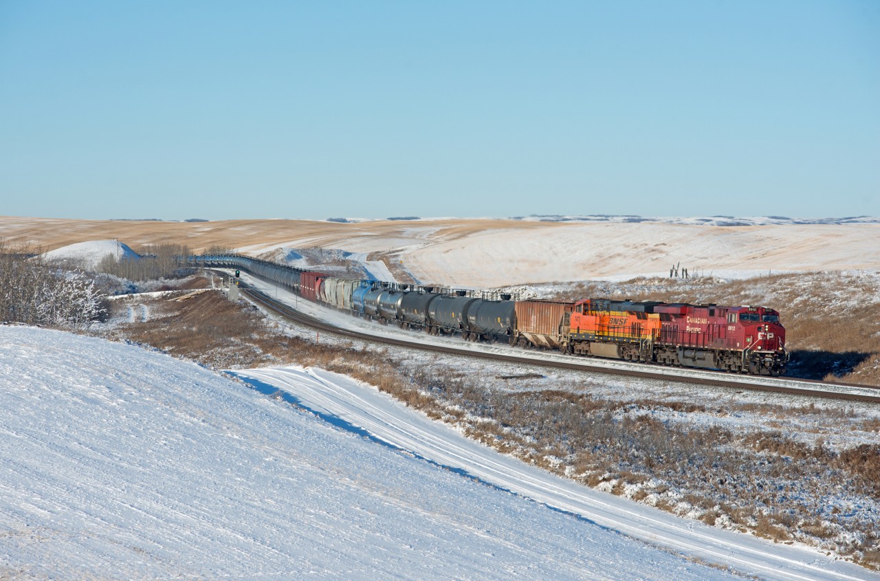 While CN was running a parade of backlit westbounds (note the clear signal indication on the close track), CP sent an eastbound through Keppel during the best light of the day. This is a loaded crude oil train out of the USD terminal at Hardisty/Rosyth that looks to have had some local traffic added to the head end.