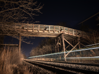 An unknown Eastbound CN train lights up the famous Denfield Road bridge on a crisp December evening before Christmas. The close paralleling of the CN and CP mains plus the little to no traffic on the bridge makes this a nice spot for one to come, sit and enjoy some railroad action. 