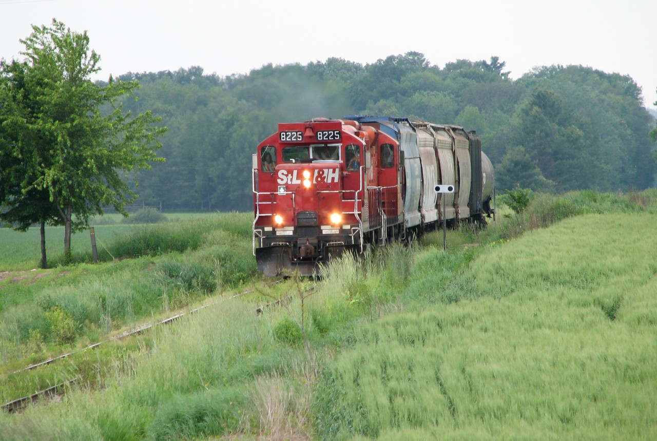 With 5 hoppers and 1 tank car in tow after switching Putnam, StL&H 8225 with CP 8234 make their way back to Woodstock.