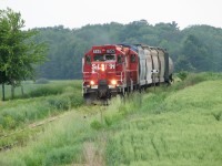 With 5 hoppers and 1 tank car in tow after switching Putnam, StL&H 8225 with CP 8234 make their way back to Woodstock. 