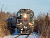 I mentioned in <a href="http://www.railpictures.ca/?attachment_id=39768" target="_blank">this shot of 108</a> that 1859 was out too, and on a whole, things were productive around Niagara on this morning. Here, 1859 has just come off the Canal Spur and onto the Harbour Spur, headed for Port Colborne with tanks for Jungbunzlauer and a couple of grain hoppers for the Port. There were hoppers sitting around the old Robin Hood mill too, so they may have had work there as well. I ventured on to other things though, and didn't follow 1859 further south on this particular day. The tanks in the background are on 108's train, which was waiting shy of the switch for 1859 to clear. The tanks are from the biodisel plant, headed for interchange at Feeder.