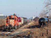 After working the propane yard at right, the St. Thomas Job shove across the diamond with the CN Cayuga Spur as they back towards Dowler-Karn with LPG loads to be spotted.