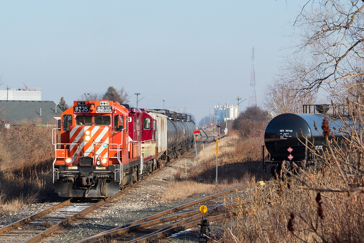 After working the propane yard at right, the St. Thomas Job shove across the diamond with the CN Cayuga Spur as they back towards Dowler-Karn with LPG loads to be spotted.